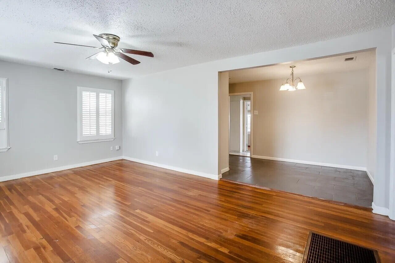 2706 36th Street Lubbock, TX 79413 - Photo 3 of 15 a view of empty room with wooden floor and fan
