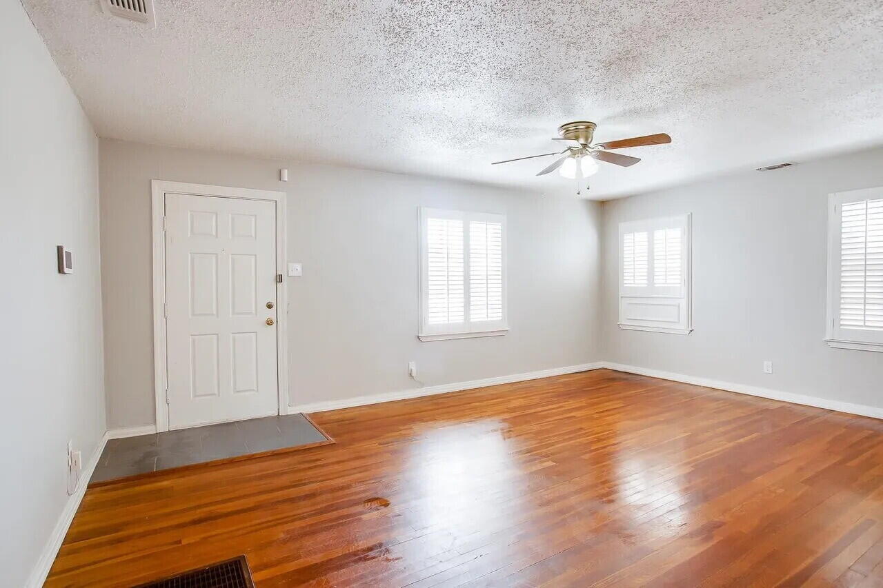 2706 36th Street Lubbock, TX 79413 - Photo 4 of 15 a view of empty room with wooden floor and fan