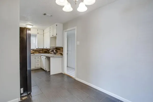 a kitchen with stainless steel appliances a refrigerator and a stove top oven