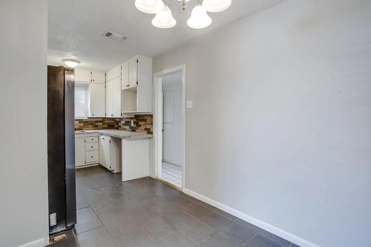 2706 36th Street Lubbock, TX 79413 - Photo 5 of 15 a kitchen with stainless steel appliances a refrigerator and a stove top oven