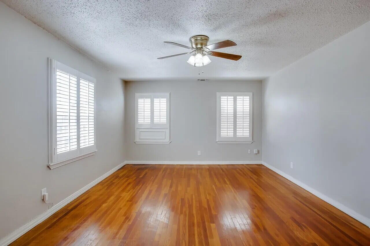 2706 36th Street Lubbock, TX 79413 - Photo 8 of 15 a view of empty room with wooden floor and fan