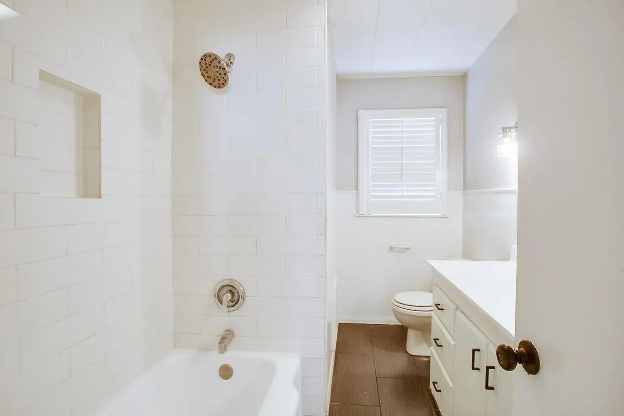 2706 36th Street Lubbock, TX 79413 - Photo 10 of 15 a bath room with a toilet sink and a bath tub