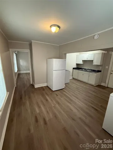 a view of a room with wooden floor and stairs