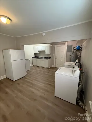 a kitchen with granite countertop a sink a stove and refrigerator