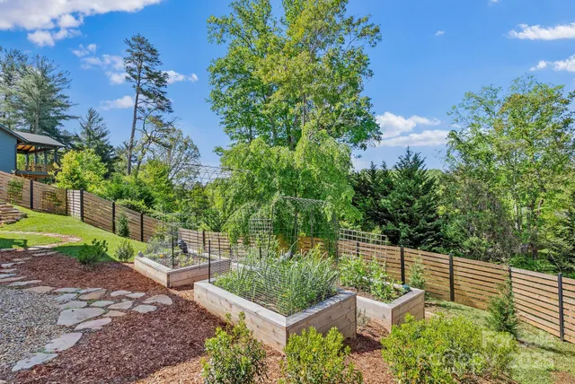 an aerial view of a house with yard and outdoor seating