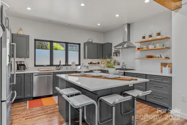 a kitchen with a sink appliances and cabinets