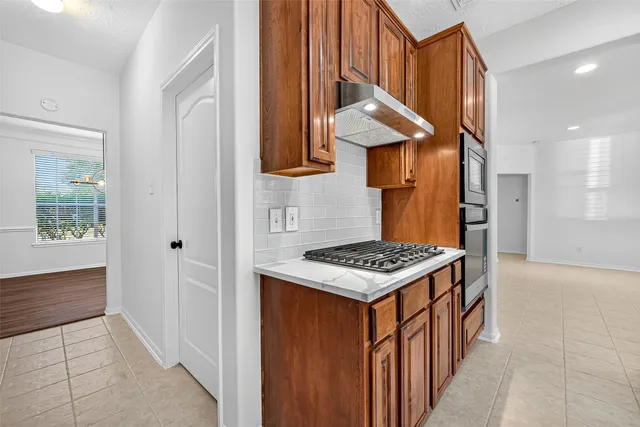 a kitchen with stainless steel appliances granite countertop a stove and a sink
