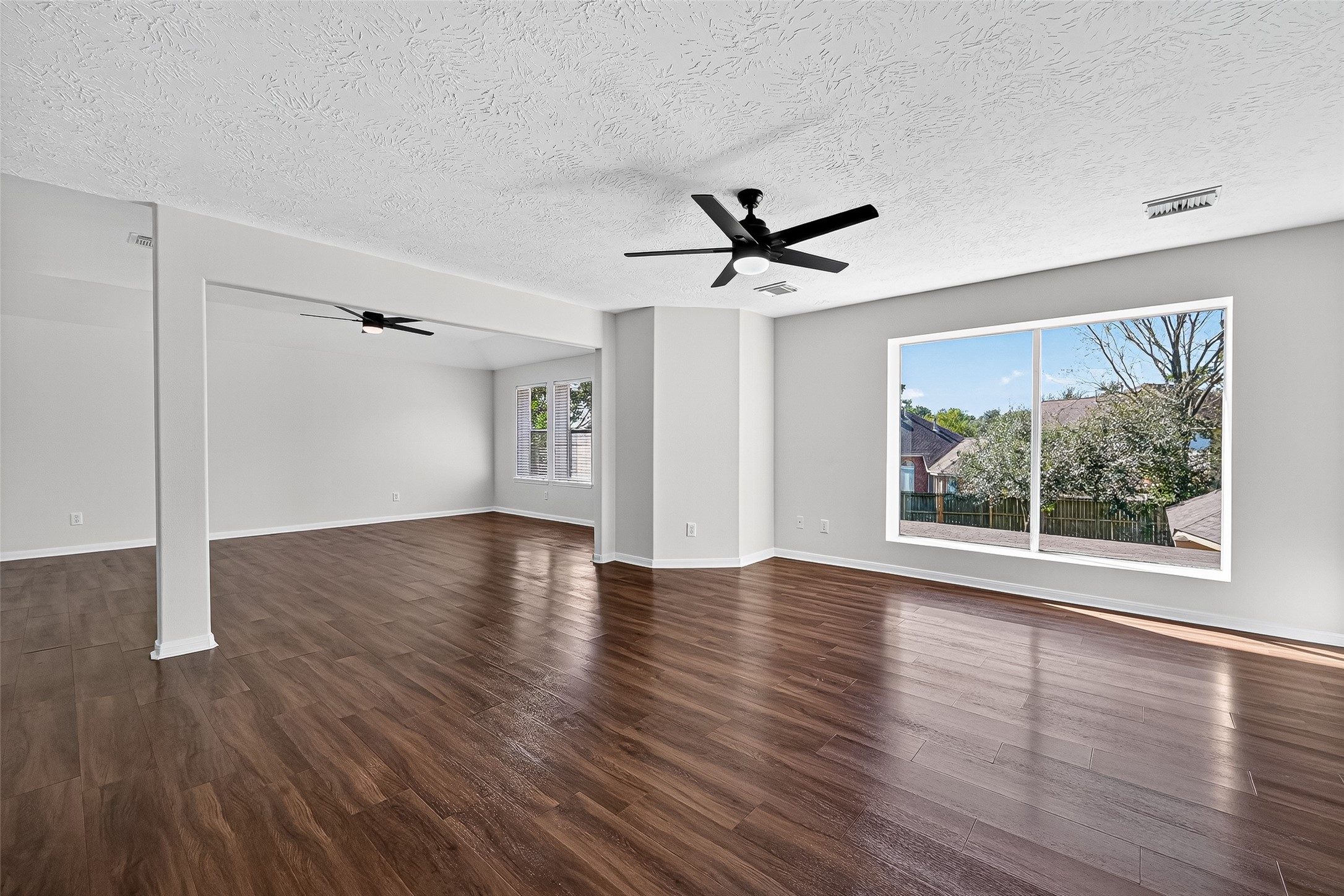 11727 Spring Path Court Tomball, TX 77377 - Photo 24 of 50 a view of an empty room with wooden floor and a window