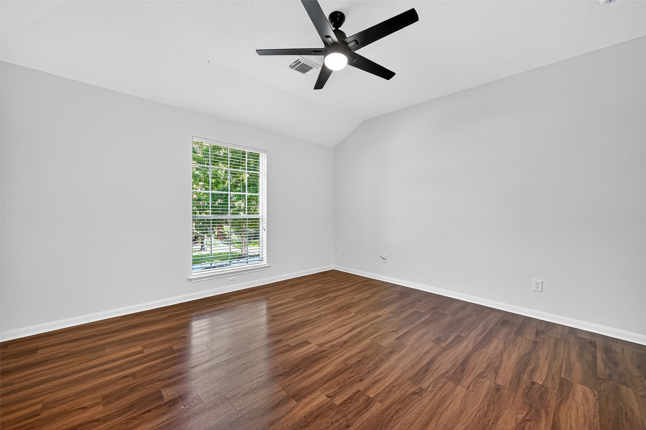 11727 Spring Path Court Tomball, TX 77377 - Photo 39 of 50 an empty room with wooden floor ceiling fan and windows