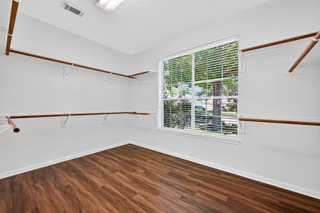 a view of a room with wooden floor and windows
