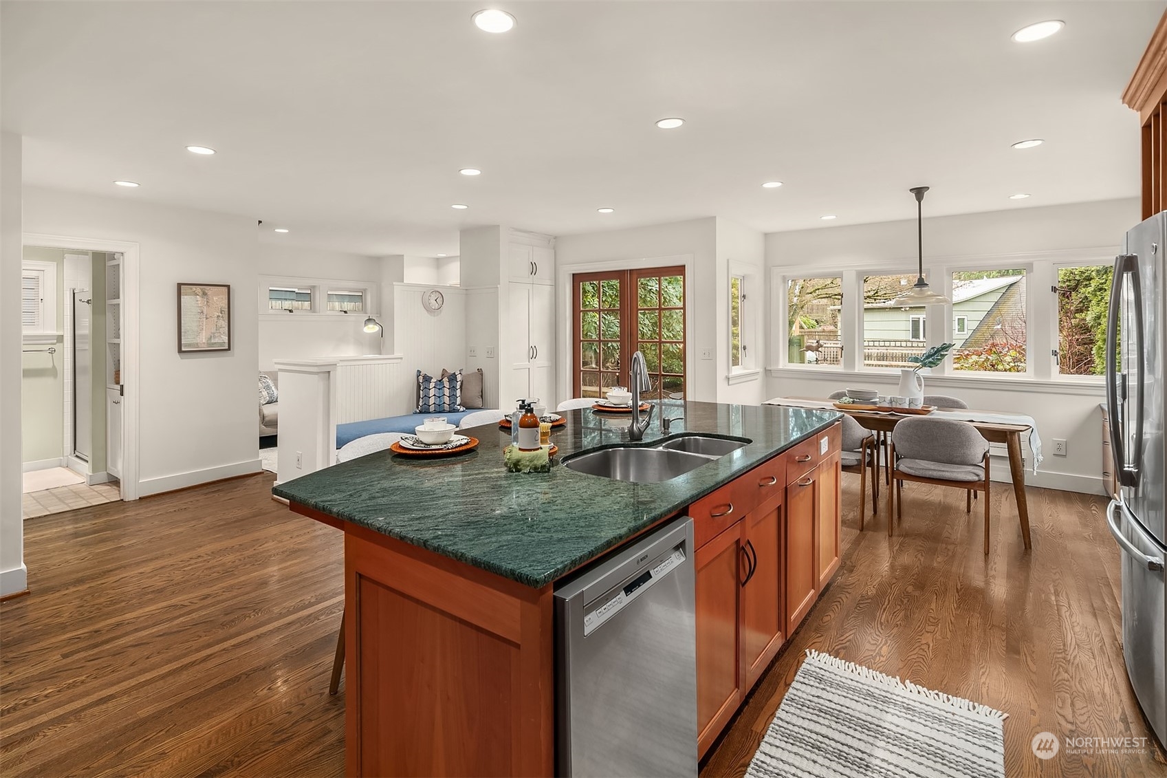 1925 East Lynn Street Seattle, WA 98112 - Photo 11 of 36 wooden floor with granite countertop a table chairs sink and wooden floor