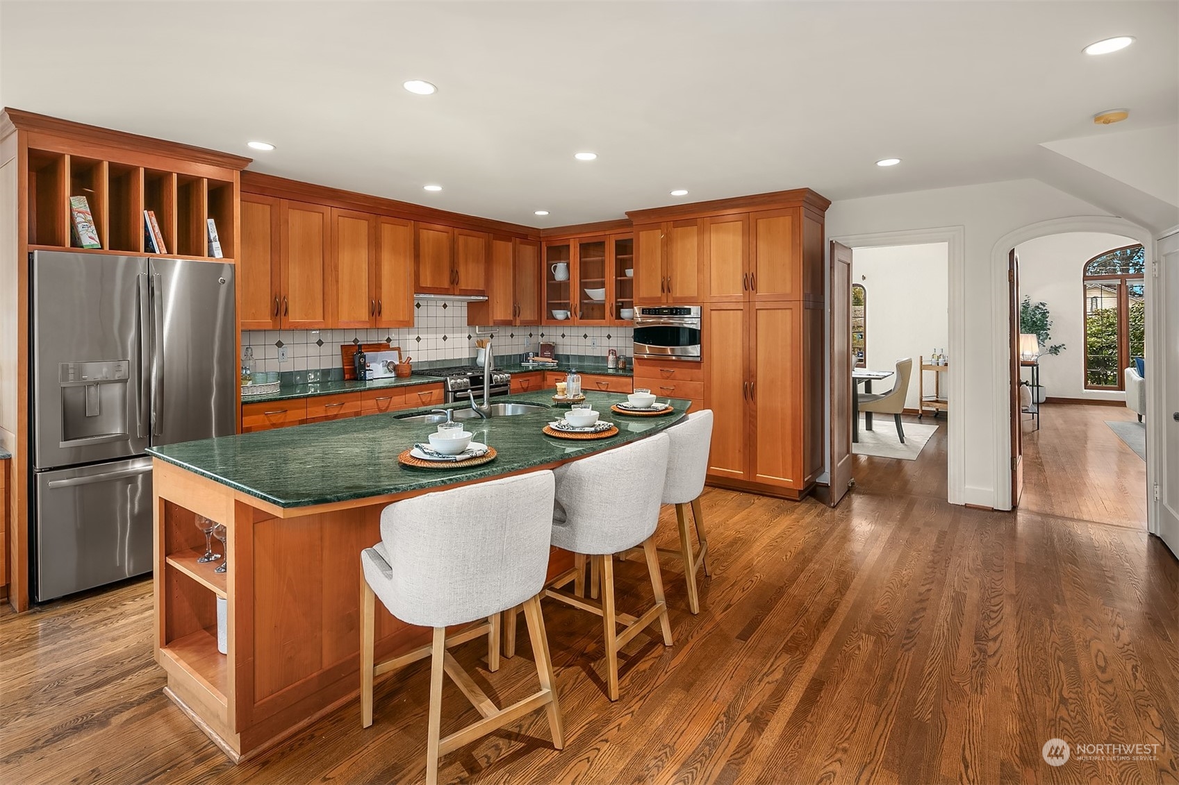 1925 East Lynn Street Seattle, WA 98112 - Photo 13 of 36 a kitchen with stainless steel appliances granite countertop a table chairs and a refrigerator
