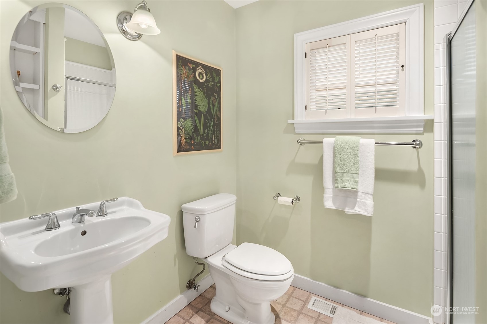 1925 East Lynn Street Seattle, WA 98112 - Photo 16 of 36 a bathroom with a sink a mirror and a toilet