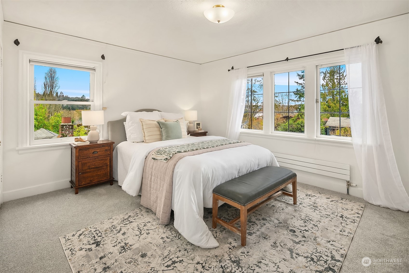 1925 East Lynn Street Seattle, WA 98112 - Photo 17 of 36 a spacious bedroom with a bed and a window