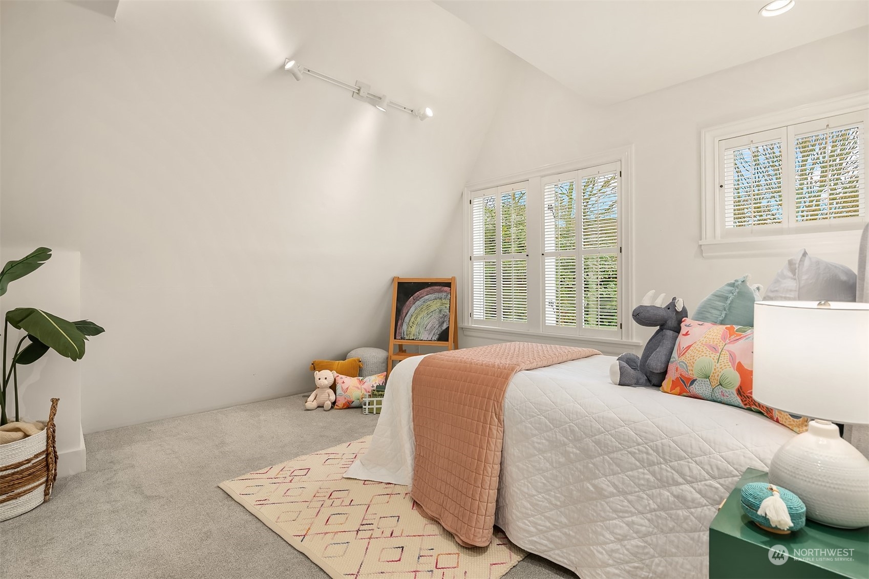 1925 East Lynn Street Seattle, WA 98112 - Photo 21 of 36 a bedroom with a bed and wooden floor