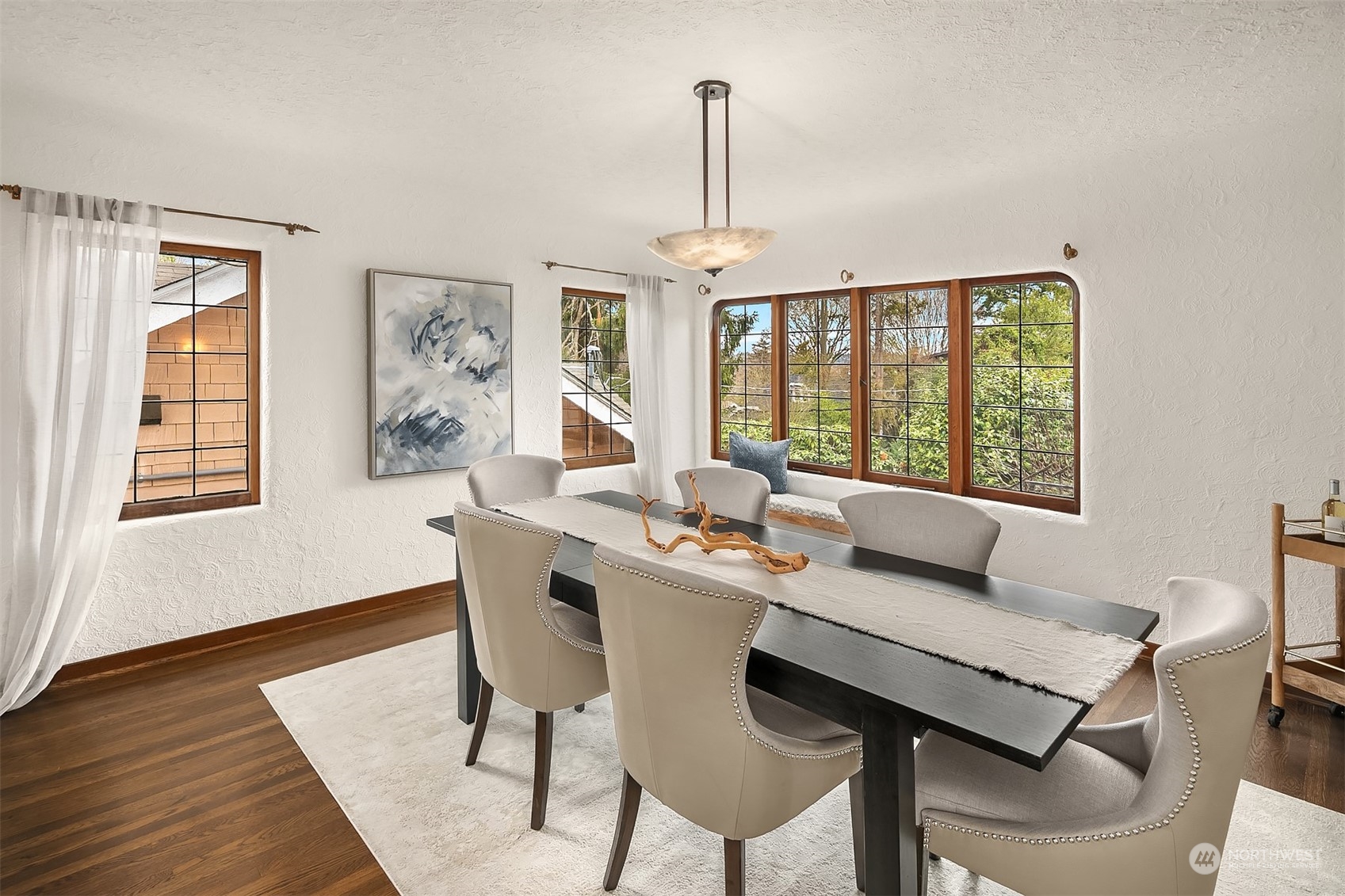 1925 East Lynn Street Seattle, WA 98112 - Photo 8 of 36 a view of a dining room with furniture wooden floor and a chandelier