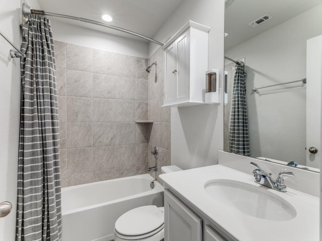 5944 Bursey Road Watauga, TX 76148 - Photo 22 of 25 a bathroom with a sink toilet and shower