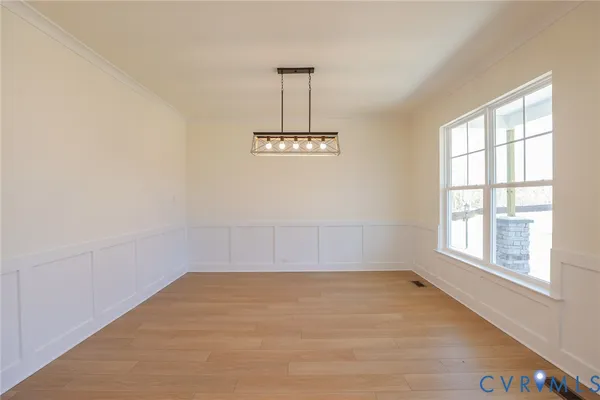 an empty room with a windows and ceiling fan