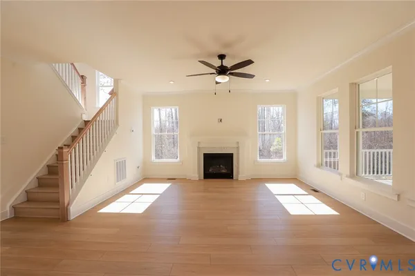 a view of an empty room with fireplace and a window
