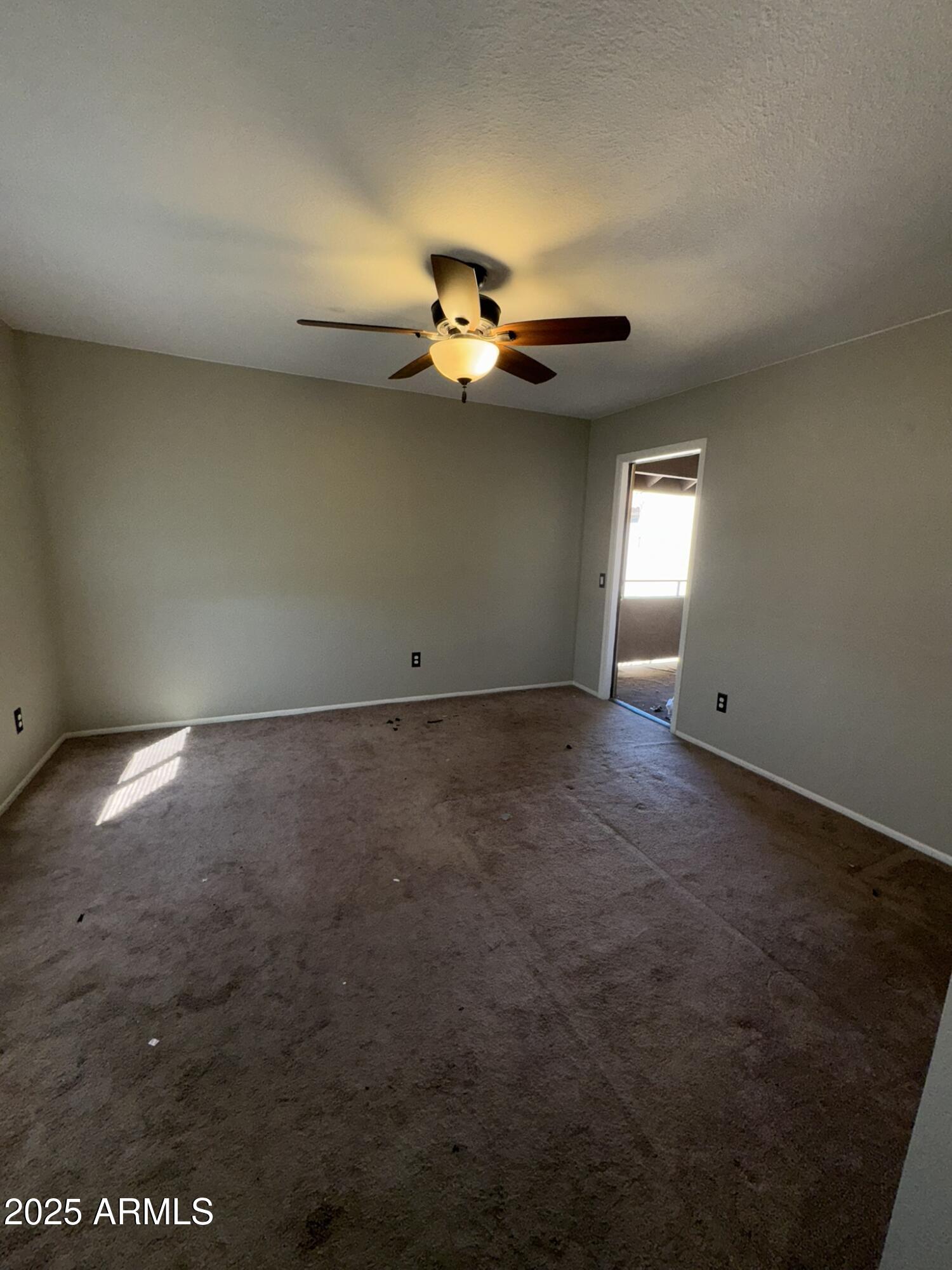 2146 West Isabella Avenue, Unit 213 Mesa, AZ 85202 - Photo 3 of 13 an empty room with windows and fan