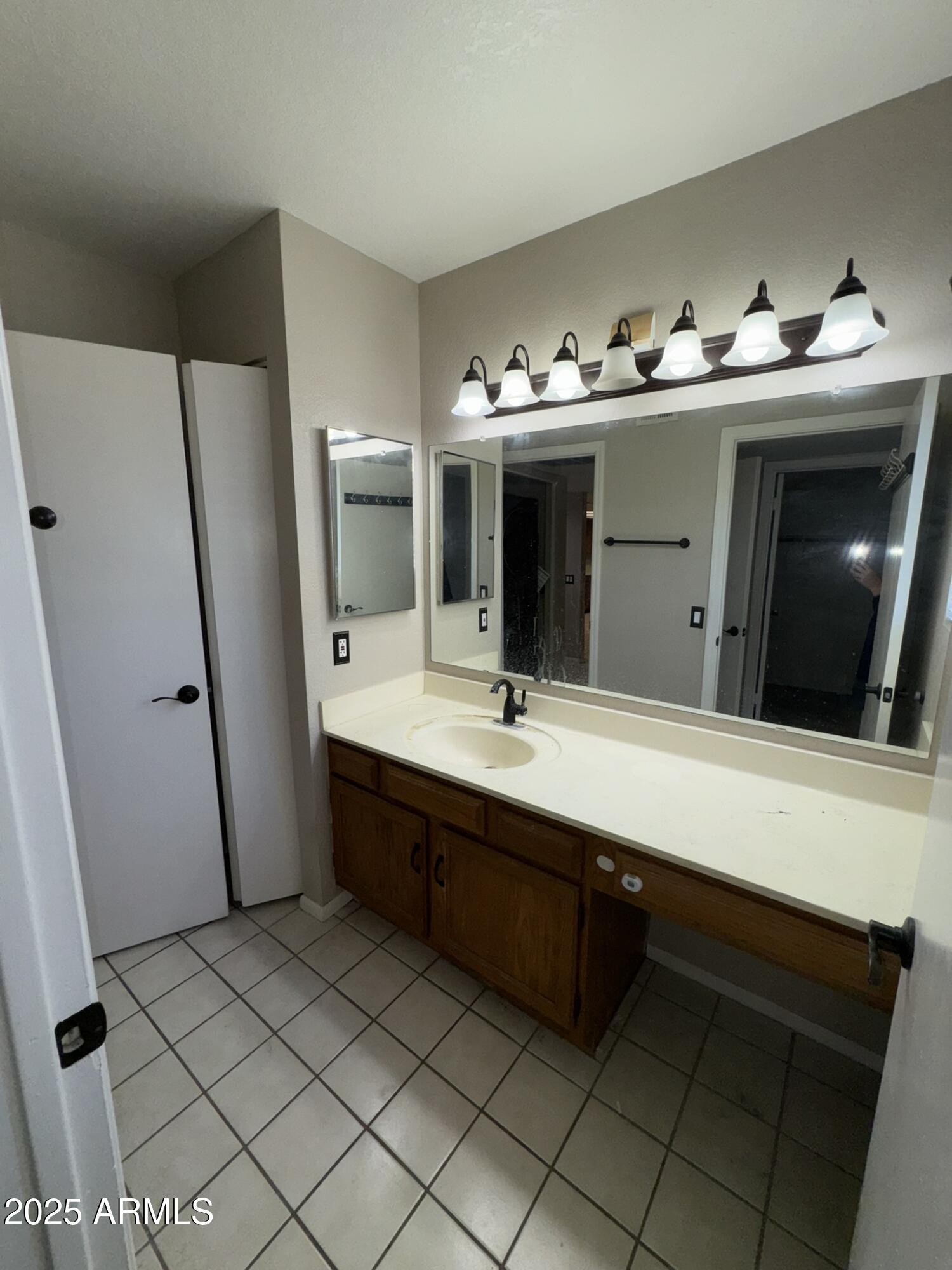 2146 West Isabella Avenue, Unit 213 Mesa, AZ 85202 - Photo 4 of 13 a bathroom with a sink and a mirror