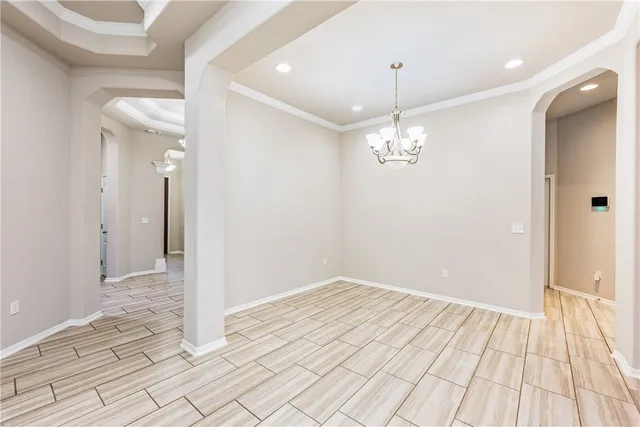 a view of a room with wooden floor and chandelier