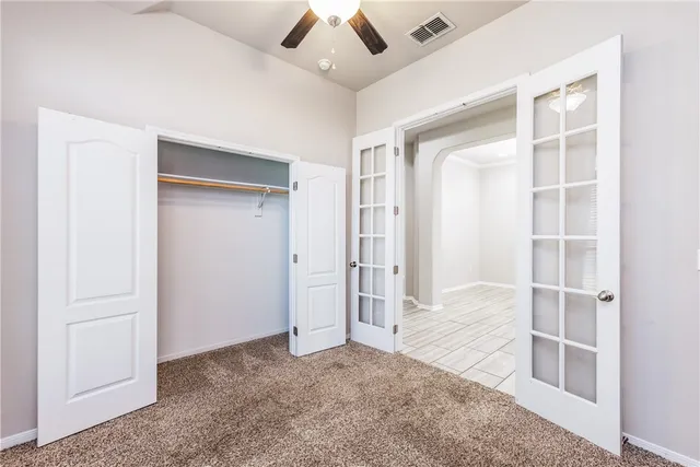 an empty room with windows and closet
