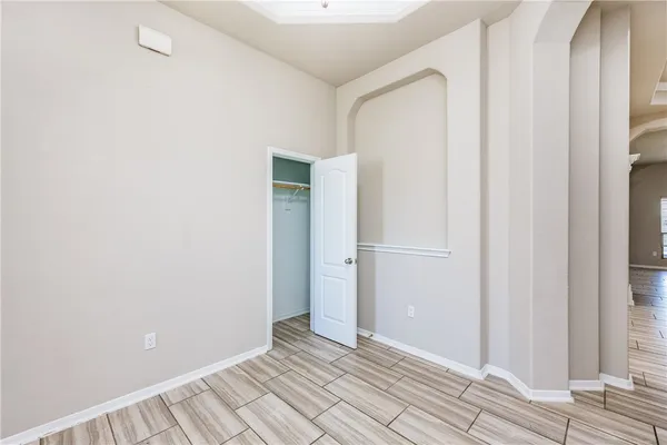 a view of an empty room with wooden floor