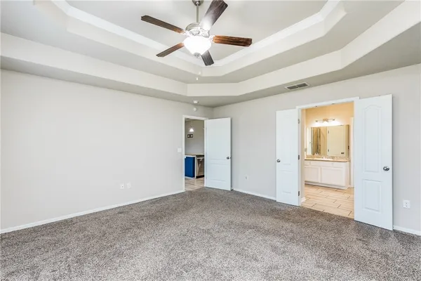 a view of an empty room and a ceiling fan