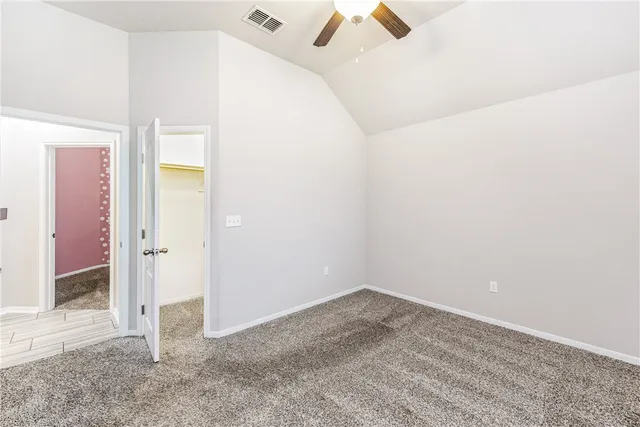 an empty room with fan and entrance