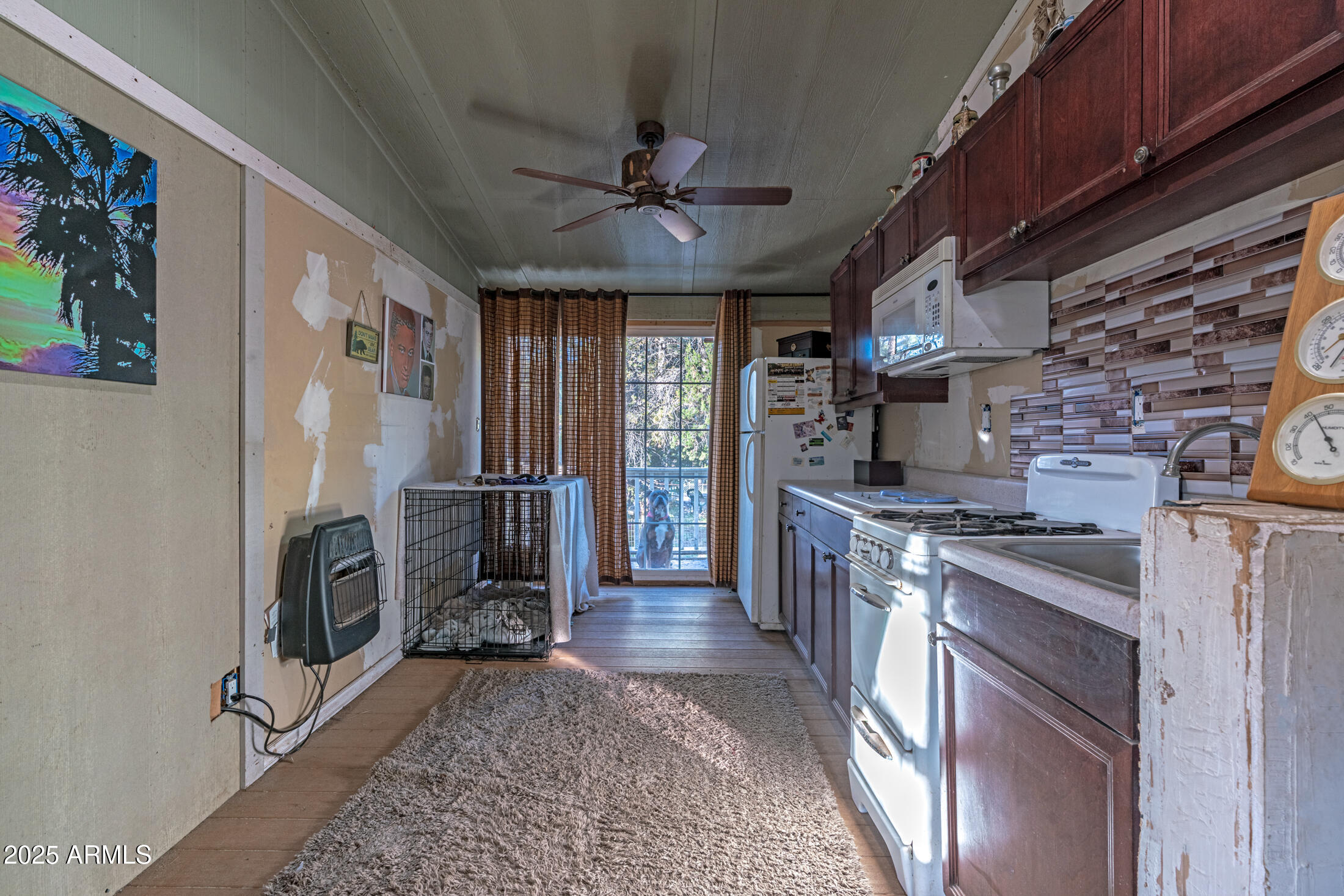 2179 Hackamore Drive Overgaard, AZ 85933 - Photo 18 of 26 a kitchen with stainless steel appliances granite countertop a stove top oven a sink dishwasher and a fireplace