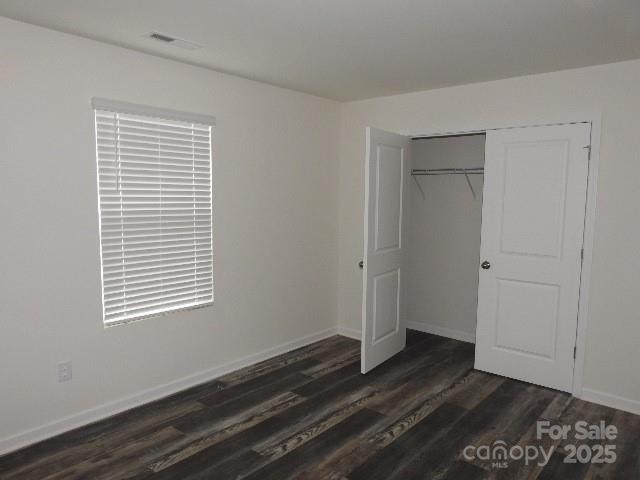 252 Mills Avenue Troutman, NC 28166 - Photo 13 of 15 a view of an empty room with wooden floor and a window