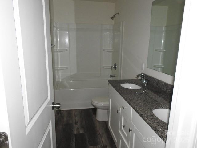 252 Mills Avenue Troutman, NC 28166 - Photo 14 of 15 a bathroom with a granite countertop sink toilet and shower
