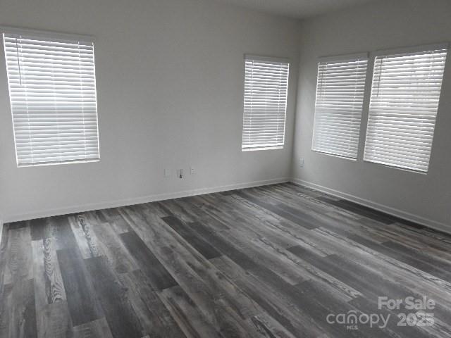 252 Mills Avenue Troutman, NC 28166 - Photo 5 of 15 a view of an empty room with wooden floor and a window