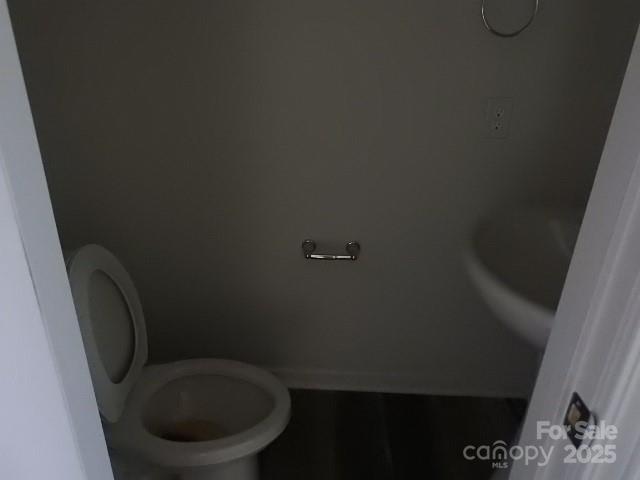 252 Mills Avenue Troutman, NC 28166 - Photo 6 of 15 a toilet sitting in a bathroom next to a sink