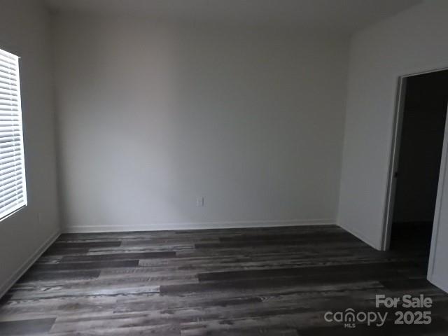 252 Mills Avenue Troutman, NC 28166 - Photo 7 of 15 a view of an empty room with wooden floor and a window
