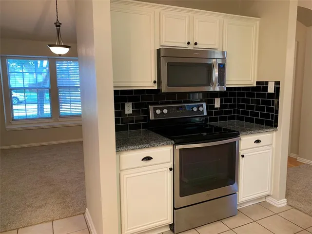 a kitchen with a stove and a microwave