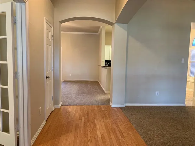 an empty room with wooden floor and a door