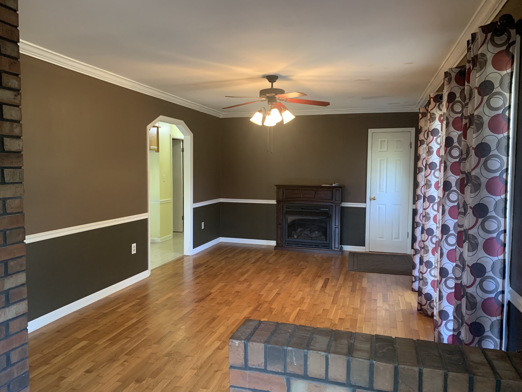 341 Busby Road Loretto, TN 38469 - Photo 26 of 42 a view of a livingroom with furniture a chandelier fan and wooden floor