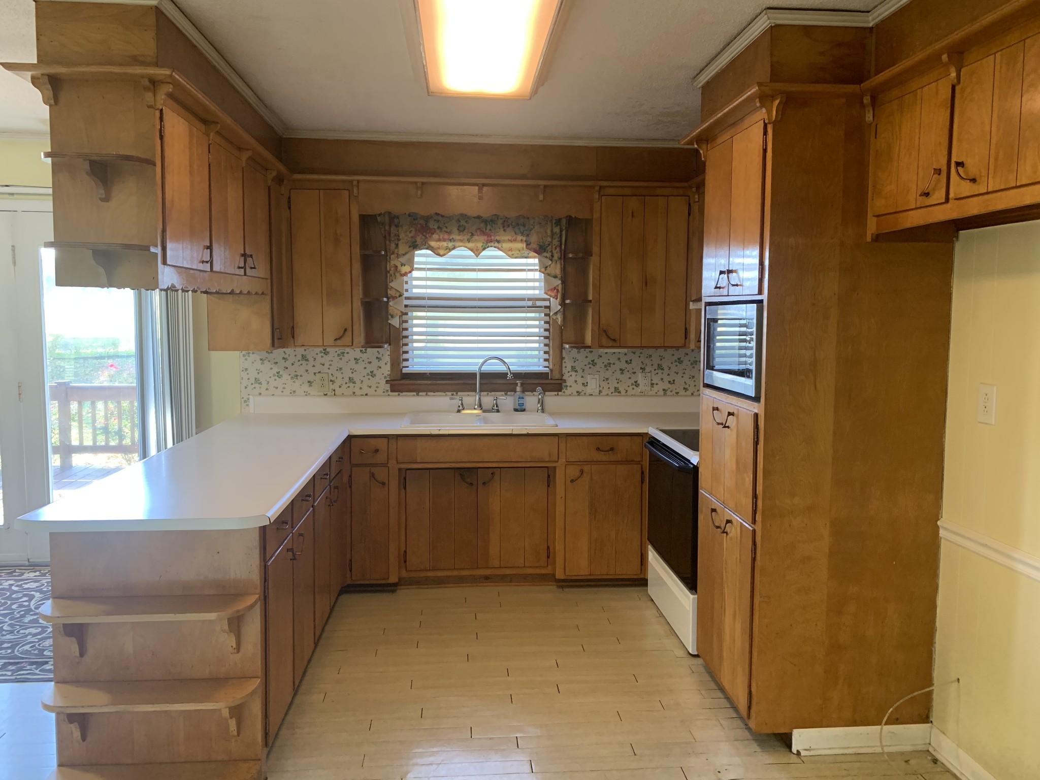 341 Busby Road Loretto, TN 38469 - Photo 31 of 42 a kitchen with stainless steel appliances granite countertop a sink and a refrigerator