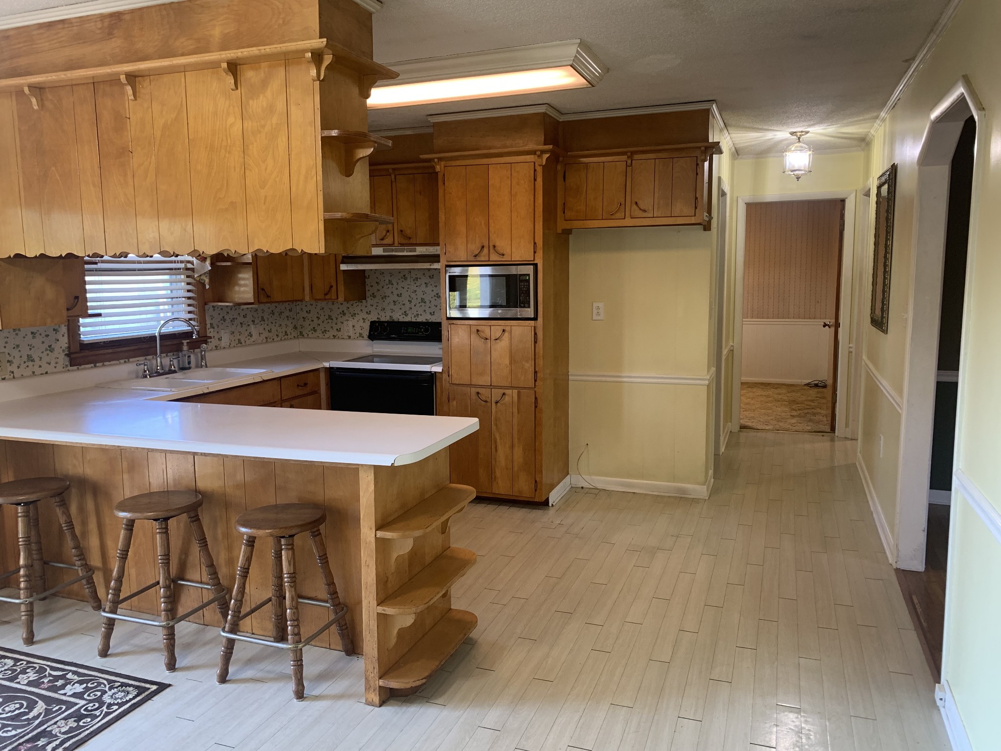 341 Busby Road Loretto, TN 38469 - Photo 34 of 42 a kitchen with kitchen island a counter top space a sink appliances and cabinets