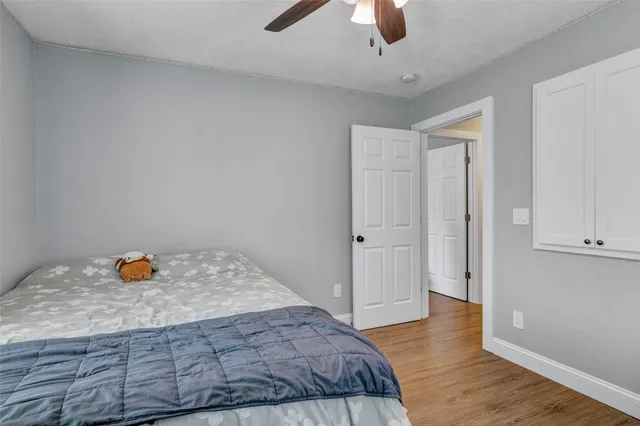 a bedroom with a bed and a ceiling fan