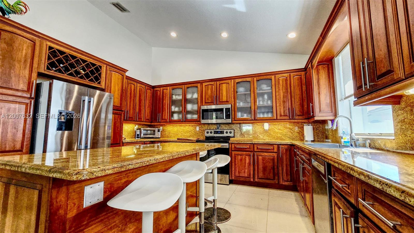 18920 Southwest 29th Street Miramar, FL 33029 - Photo 6 of 6 a kitchen with stainless steel appliances granite countertop a sink table and chairs