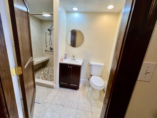 a bathroom with a toilet a sink and a window