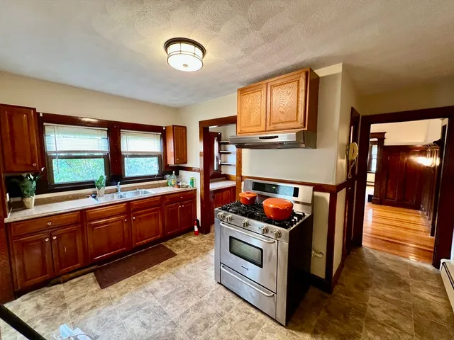 a kitchen with sink and large window