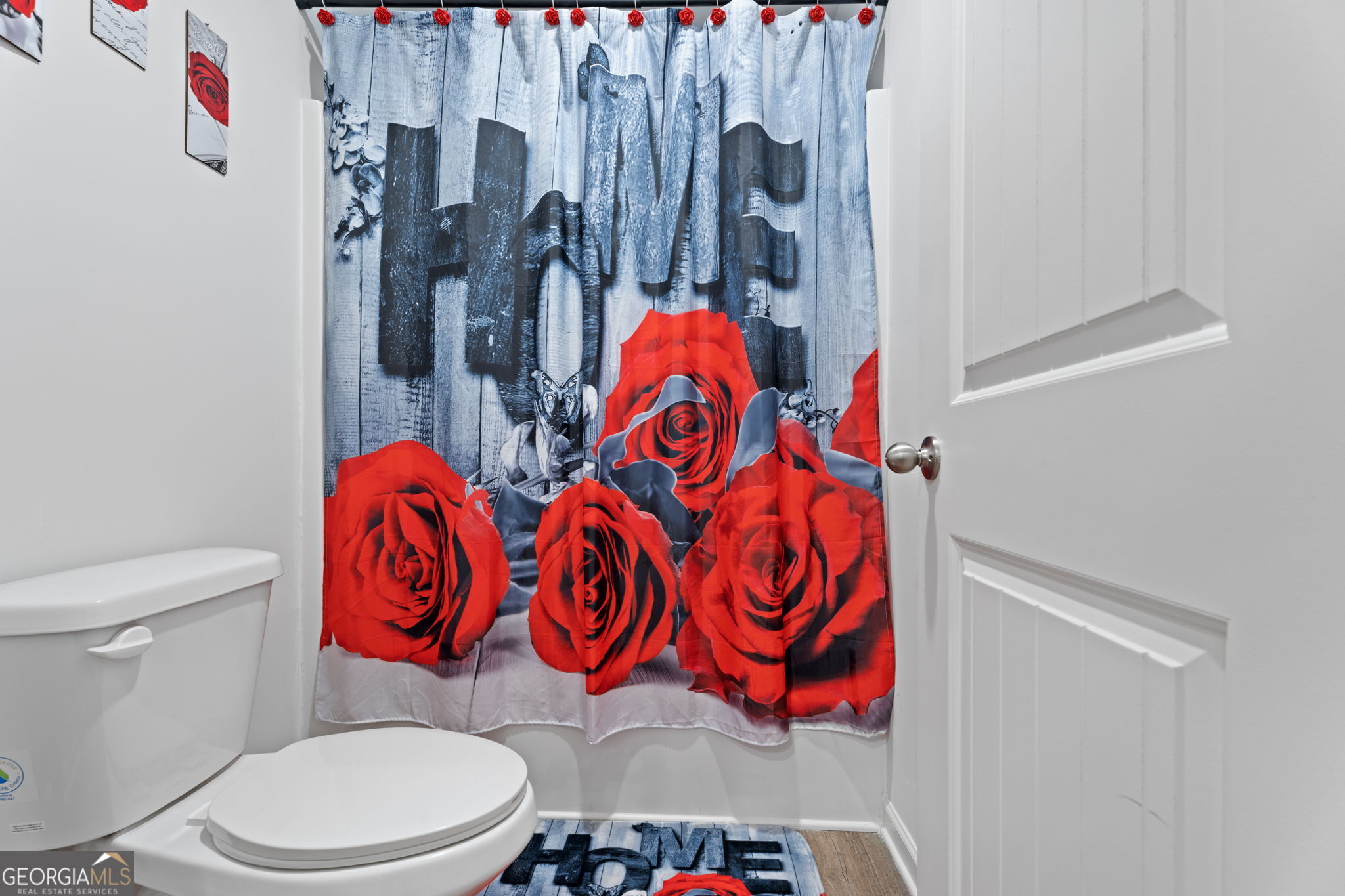 321 Kirt's Ridge Jackson, GA 30233 - Photo 36 of 57 a bathroom with a toilet and a shower curtain