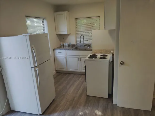 a kitchen with a refrigerator sink and stove