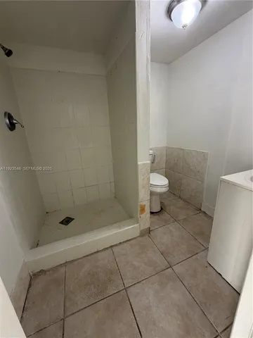 a bathroom with a shower and a toilet