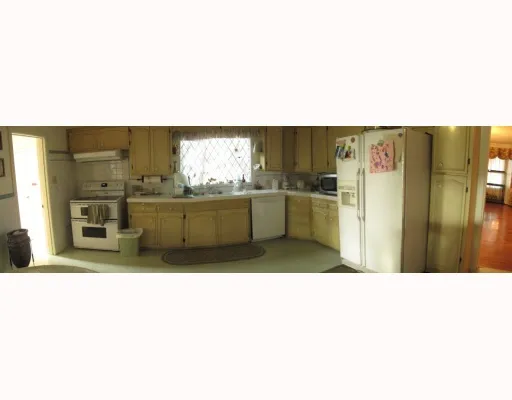 a kitchen with stainless steel appliances granite countertop a sink and cabinets