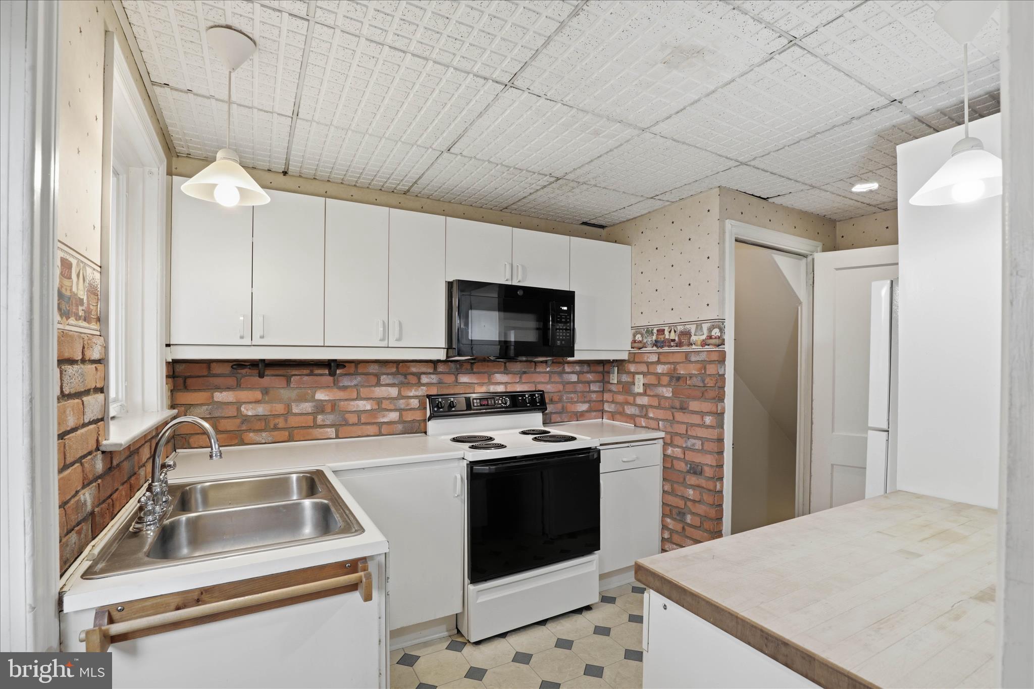 1632 Lampeter Road Lancaster, PA 17602 - Photo 16 of 46 a kitchen that has a sink a stove and a microwave